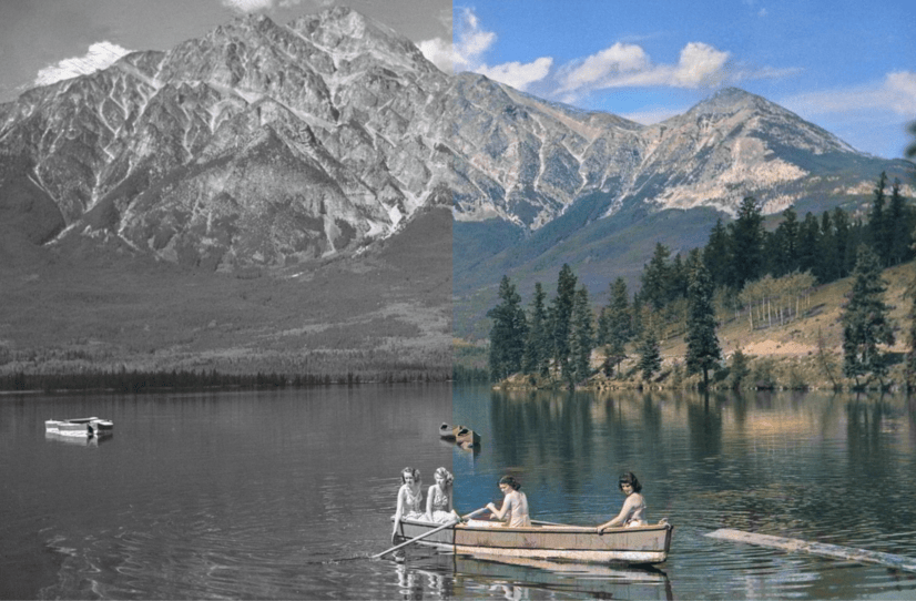 Black and white photo of people in a boat on a lake